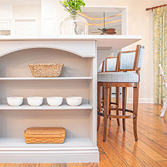 kitchen shelf with bowls and baskets underneath countertop 