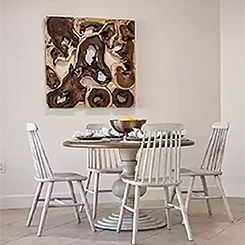 kitchen table setting with artwork hanging on wall behind