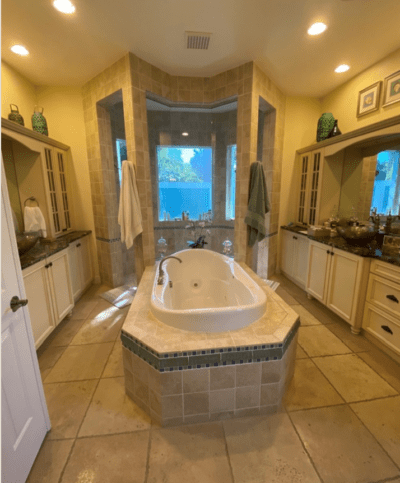 The built-in tub, dark brown granite countertops, and closed cabinets were not delivering the luxury spa experience vibe our Apollo Beach clients wanted.