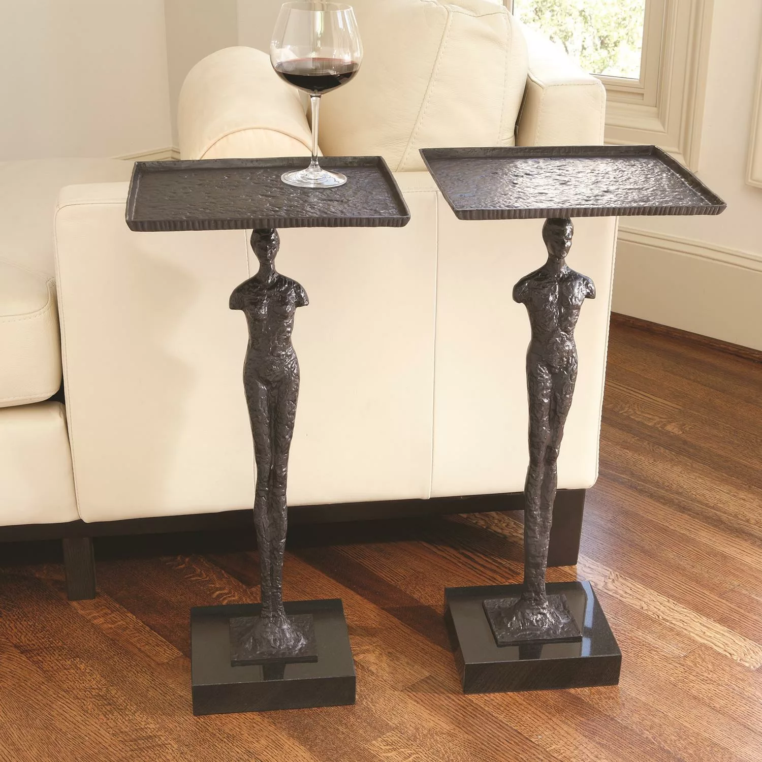 two side tables with a glass of wine on top